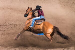 Cowgirl,Riding,Her,Horse,In,A,Barrel,Race,At,A